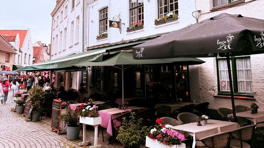 Een terras met een zonnescherm en parasol.